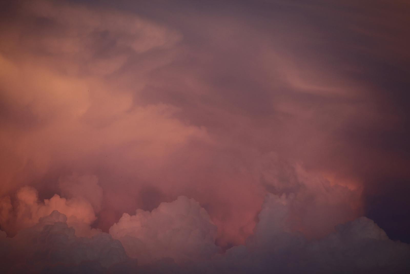 A dramatic sunset cloudscape with vivid hues of orange and pink, creating a mesmerizing natural scene.